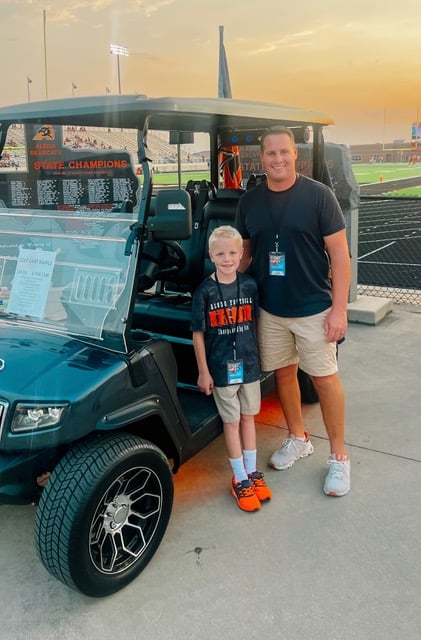 Aledo Golf Carts — a customer and his son with their golf cart
